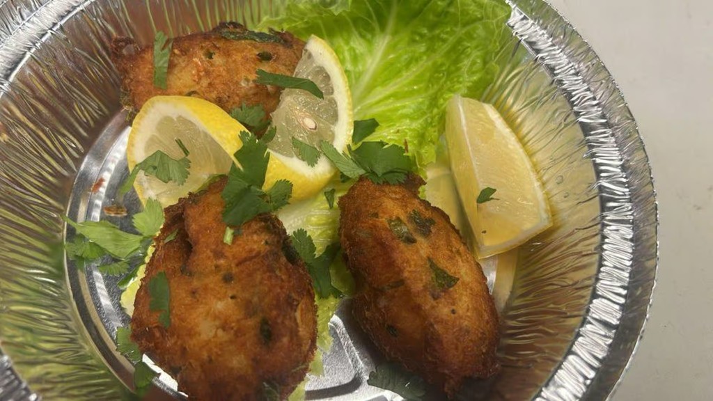Codfish cakes with lemon and greens