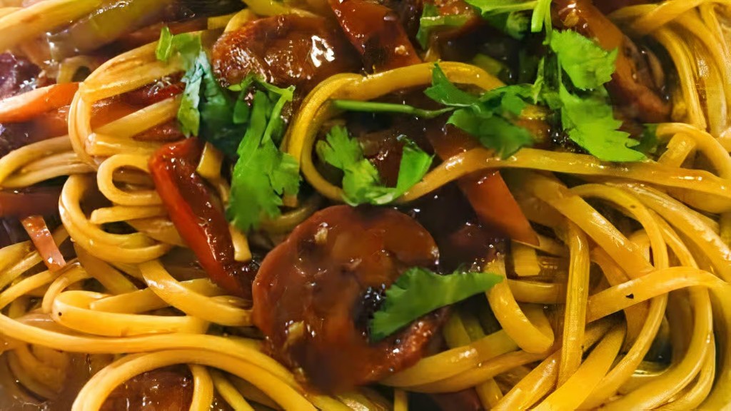 Linguine tossed with chorizo, peppers, and cilantro in a tomato-based sauce